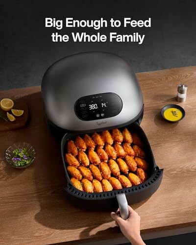 Air fryer with cooked chicken wings and digital display.