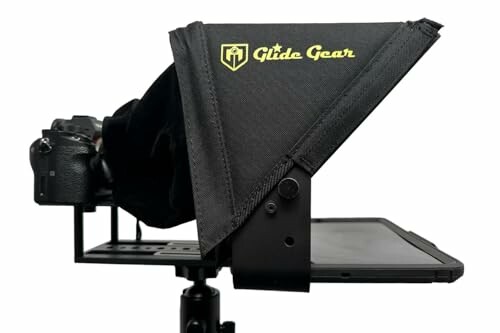 Camera with teleprompter setup on a tripod.