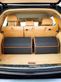 Open car trunk with two large storage boxes inside.