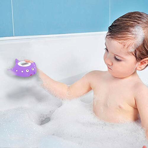 Child playing with a purple bath toy in a bathtub.