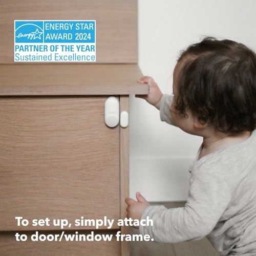 Child installing safety lock on cabinet.