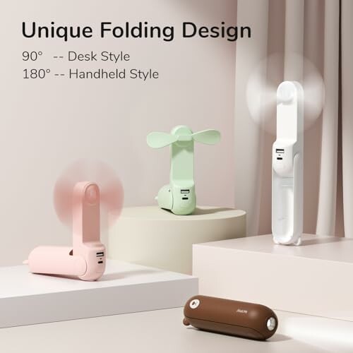 Three portable fans with unique folding design in pastel colors.
