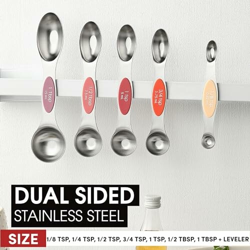 Set of dual-sided stainless steel measuring spoons with size labels.