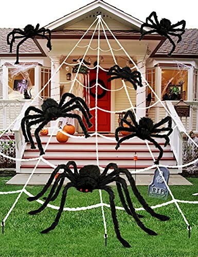Halloween decoration with large spider web and giant spiders on a porch.