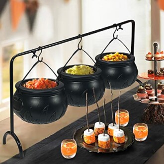 Halloween cauldron snack display with treats and cupcakes