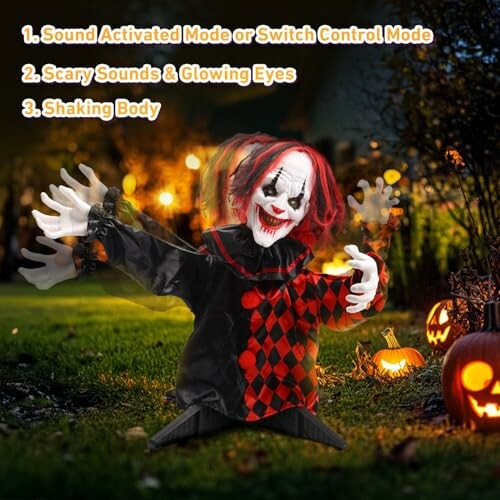 Creepy clown decoration with glowing eyes and pumpkins.
