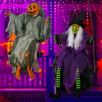 Halloween decorations: pumpkin-headed figure and witch on swings.