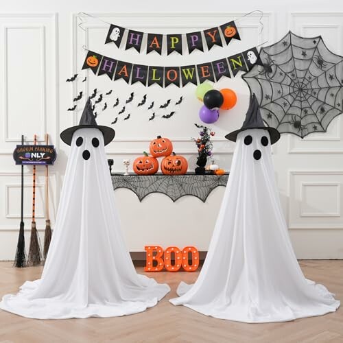Halloween decorations with ghost figures and pumpkins.