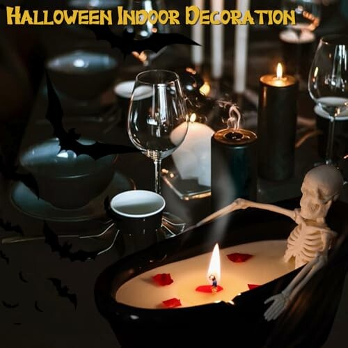 Halloween-themed table with candles, skeleton, and glasses.