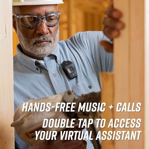 Construction worker using hands-free device for music and calls.