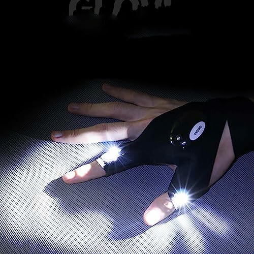 Hand wearing LED flashlight glove illuminating surface.