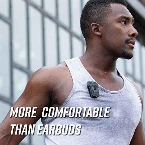 Man wearing a wireless audio device on his tank top.