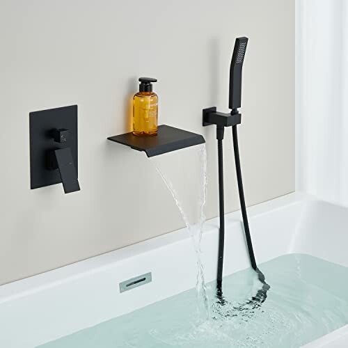 Modern bathtub faucet with water flowing and showerhead.