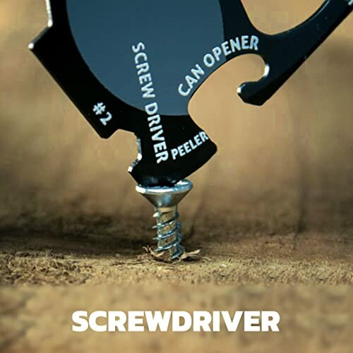 Multi-tool being used to drive a screw into wood