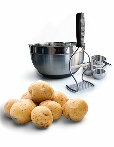 Potatoes with a masher, metal bowl, and measuring cups.