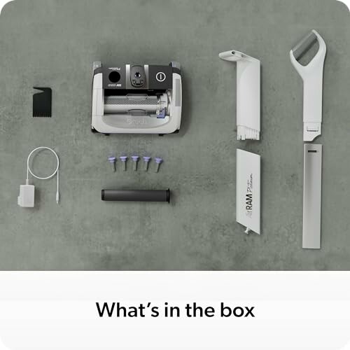 Contents of a robot vacuum box including parts and accessories.