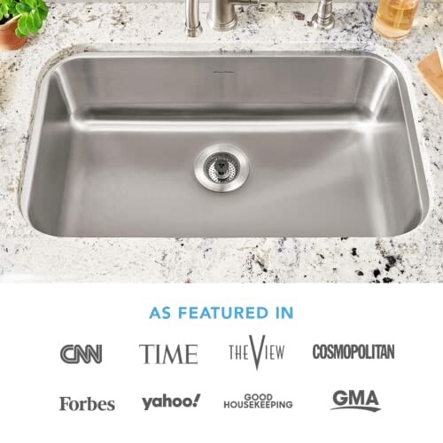 Stainless steel kitchen sink with featured brand logos.